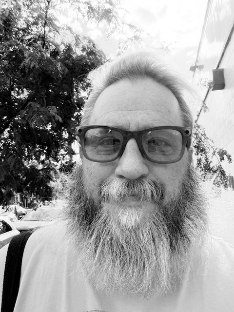 Jason, founder of New To Northern Liberties, a bearded man in glasses on a city sidewalk